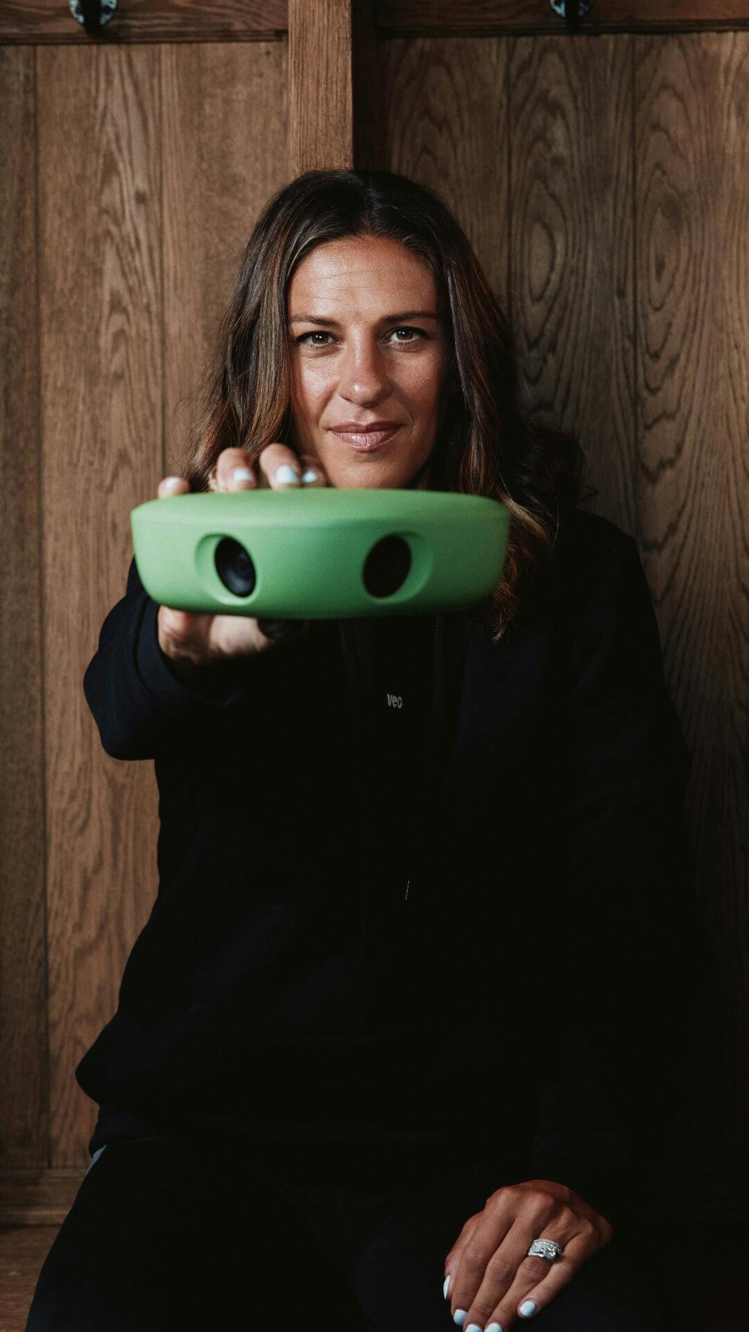 Carli Lloyd posing with a soccer camera